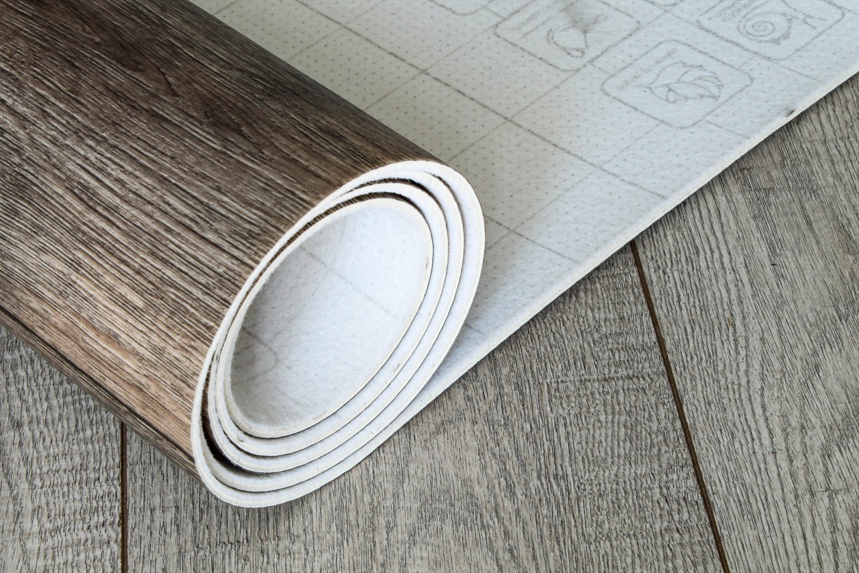Roll of linoleum with a wood texture. Types of floor coverings. PVC.