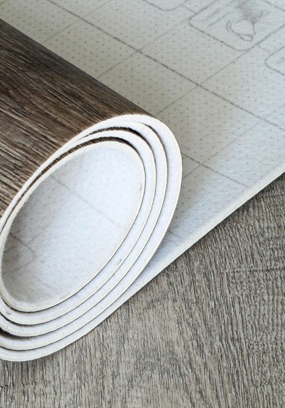 Roll of linoleum with a wood texture. Types of floor coverings. PVC.